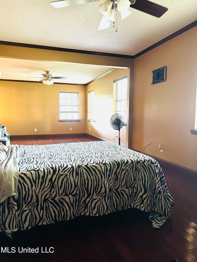 bedroom with hardwood / wood-style floors, crown molding, a textured ceiling, and ceiling fan