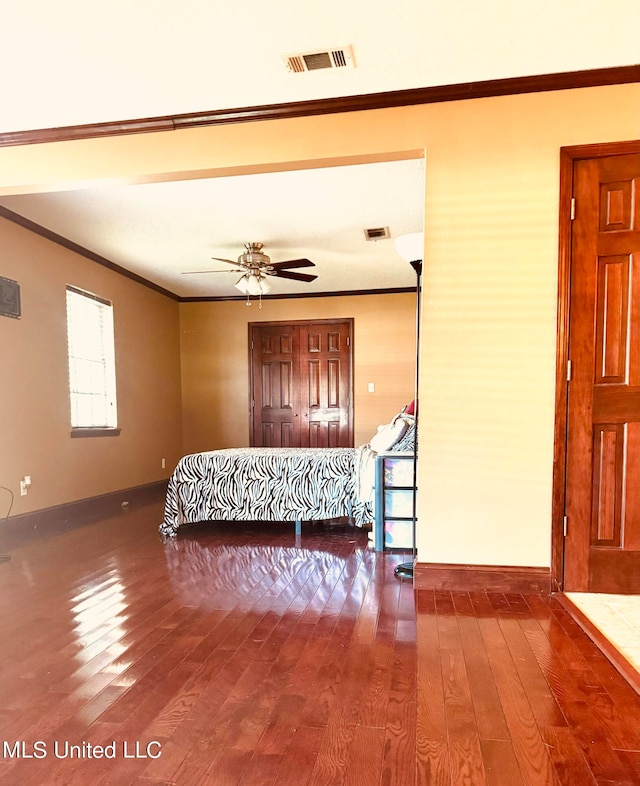 bedroom with crown molding and hardwood / wood-style floors