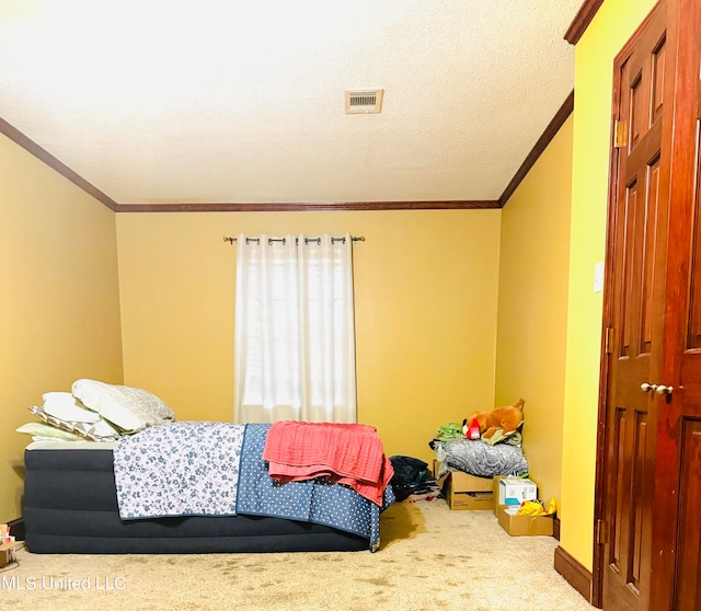 bedroom featuring carpet flooring, a textured ceiling, and ornamental molding