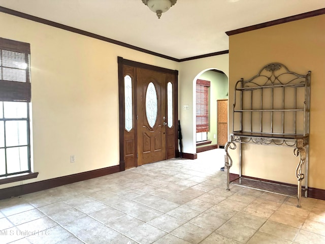 entryway featuring crown molding and a healthy amount of sunlight