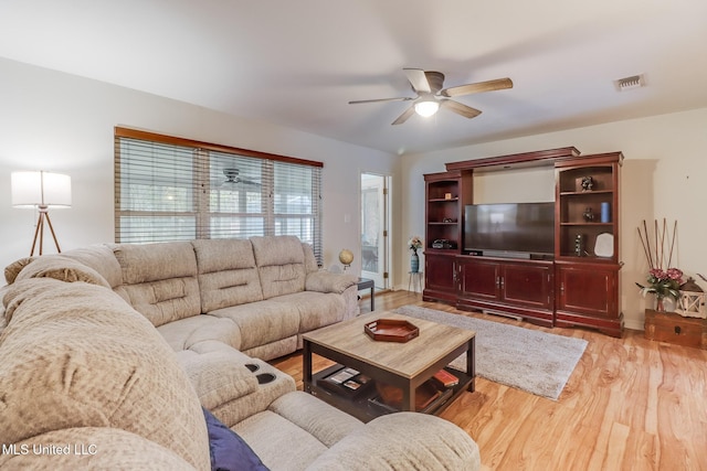 living room with visible vents, a ceiling fan, baseboards, and wood finished floors