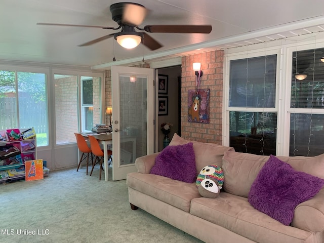 living area with carpet and ceiling fan