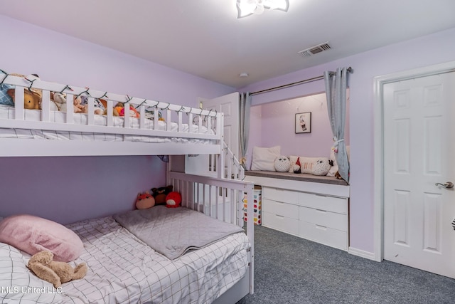 carpeted bedroom featuring visible vents