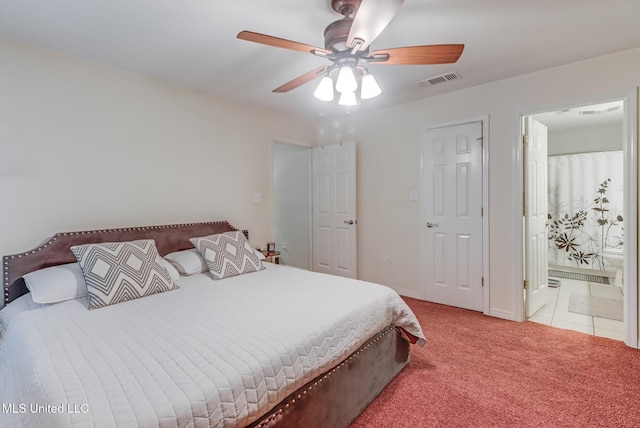 carpeted bedroom with visible vents, connected bathroom, ceiling fan, and baseboards