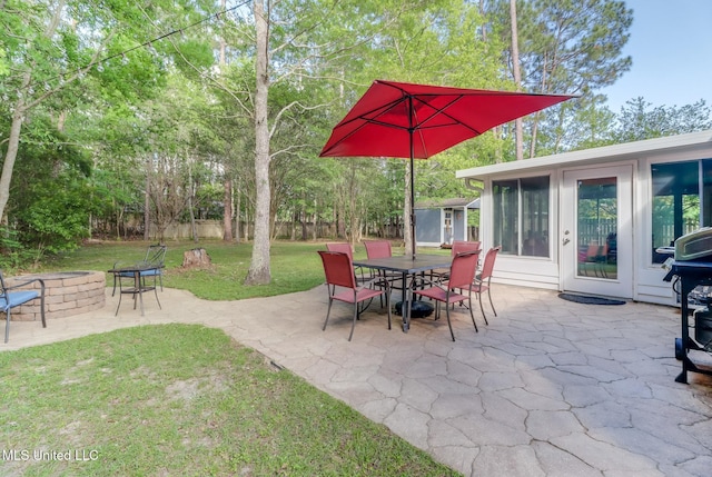 view of patio / terrace featuring fence, a fire pit, and outdoor dining space