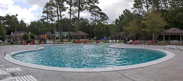 community pool with a gazebo, a patio area, and playground community