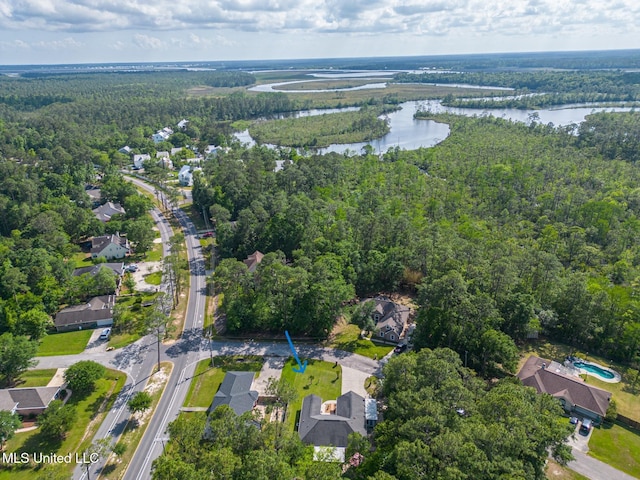 bird's eye view with a water view, a view of trees, and a residential view