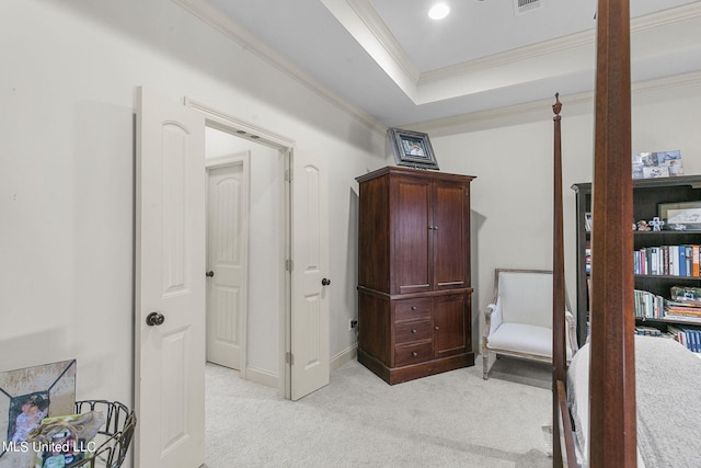 carpeted bedroom featuring a raised ceiling and ornamental molding