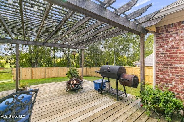 deck with an outdoor fire pit and a pergola