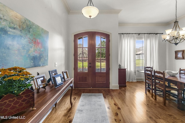 entrance foyer featuring french doors, plenty of natural light, and hardwood / wood-style floors