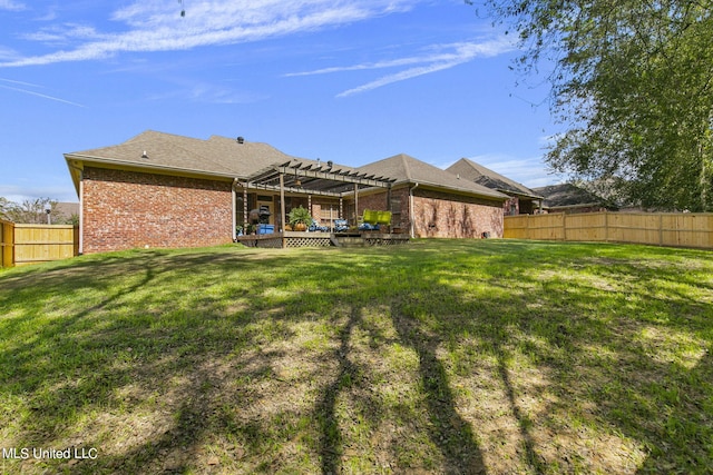 rear view of property featuring a yard, a patio area, and a pergola