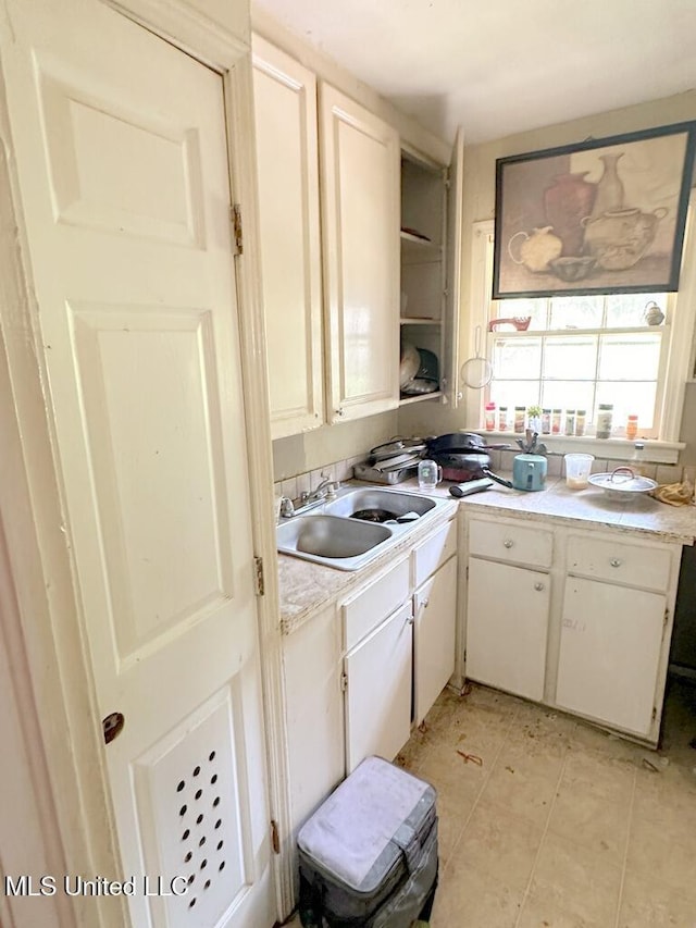 3755 Jayne Ave, Jackson, MS 39209 - kitchen featuring a sink, light countertops, white cabinets, and open shelves