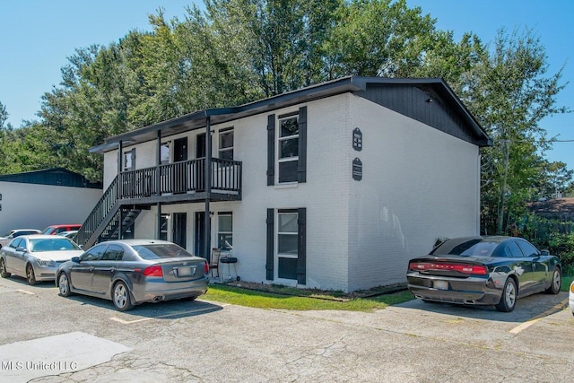 view of front of home with brick siding and stairs