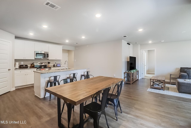 dining area featuring hardwood / wood-style flooring and sink