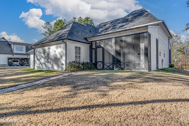 exterior space with a sunroom and a yard