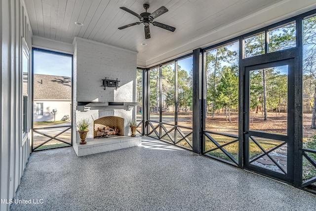 unfurnished sunroom with ceiling fan and wood ceiling