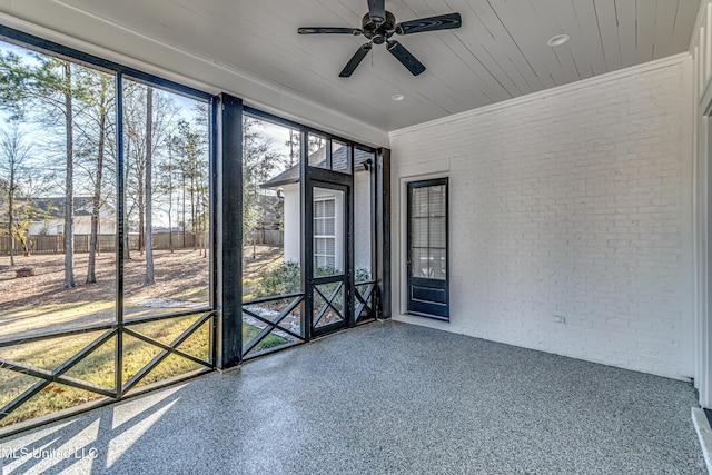 unfurnished sunroom with ceiling fan and wooden ceiling