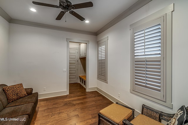 sitting room with ceiling fan, dark hardwood / wood-style flooring, and ornamental molding