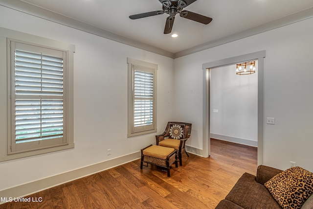 sitting room with ceiling fan, a wealth of natural light, and light hardwood / wood-style floors