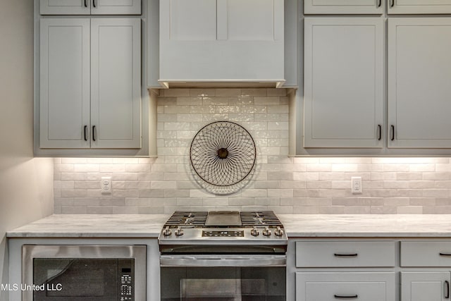 kitchen featuring stainless steel range with gas cooktop, backsplash, and built in microwave