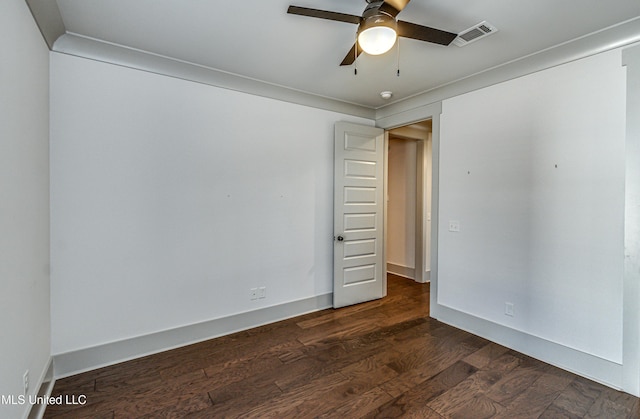 empty room featuring ceiling fan, dark hardwood / wood-style flooring, and ornamental molding