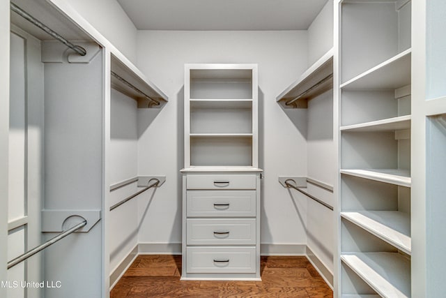 walk in closet featuring dark hardwood / wood-style flooring