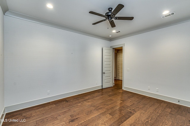 spare room featuring ceiling fan and dark wood-type flooring