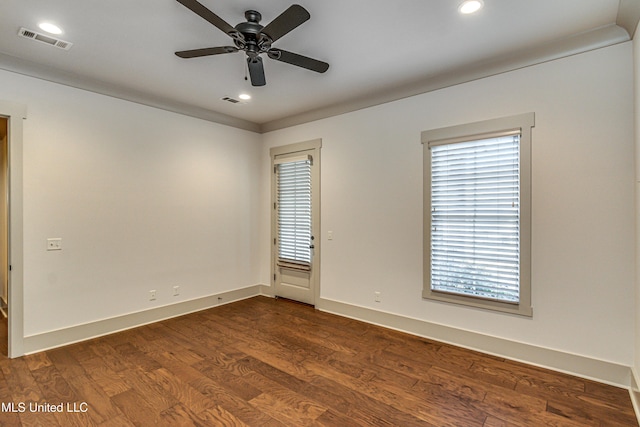 empty room with ceiling fan and dark hardwood / wood-style floors