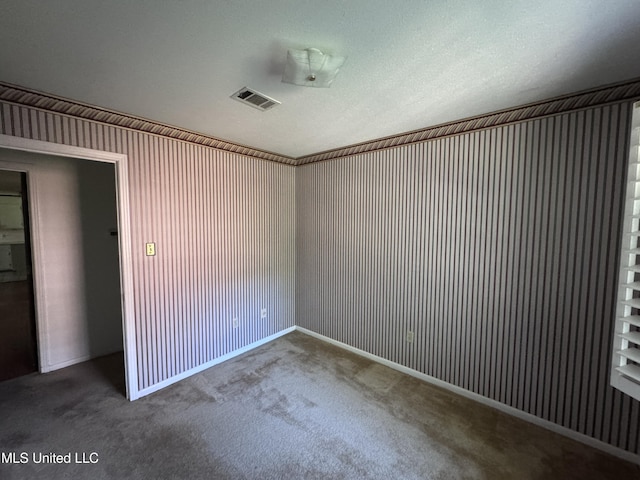 spare room with carpet and baseboards