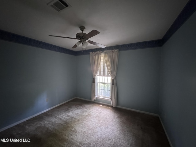 carpeted empty room featuring a ceiling fan and baseboards