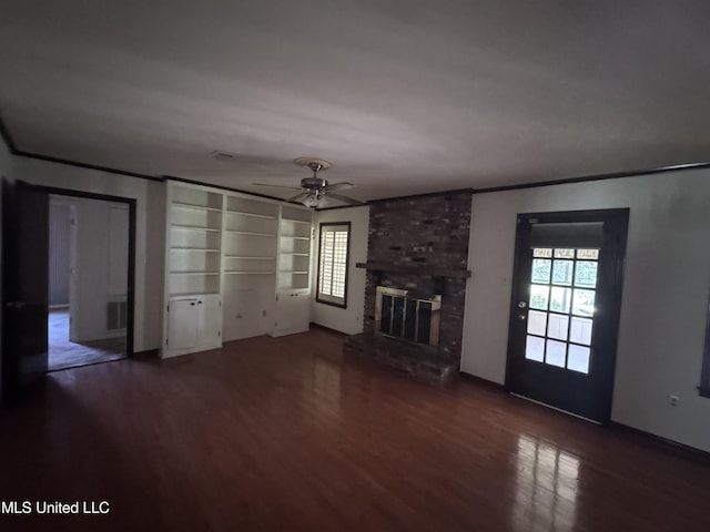 unfurnished living room featuring wood finished floors, a ceiling fan, crown molding, and a fireplace