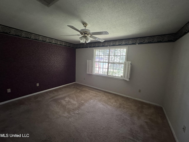 unfurnished room with ceiling fan, carpet floors, baseboards, and a textured ceiling