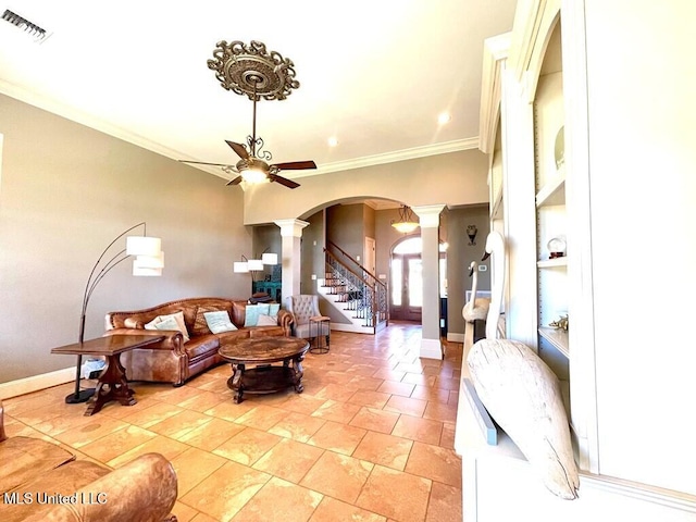6 Lunker Ln, Poplarville, MS 39470 - living area featuring decorative columns, ceiling fan, arched walkways, crown molding, and stairs