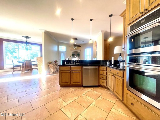 6 Lunker Ln, Poplarville, MS 39470 - kitchen with stainless steel appliances, crown molding, dark countertops, healthy amount of natural light, and hanging light fixtures