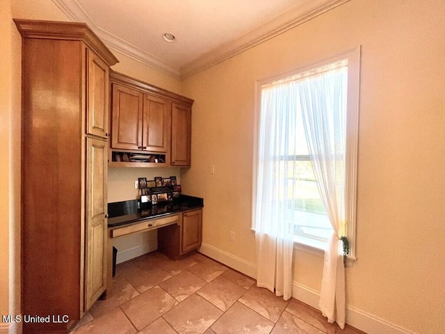 6 Lunker Ln, Poplarville, MS 39470 - kitchen with brown cabinetry, baseboards, crown molding, and dark countertops