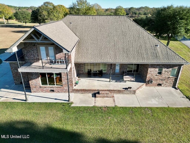 6 Lunker Ln, Poplarville, MS 39470 - rear view of house featuring brick siding, a patio area, french doors, a lawn, and a balcony