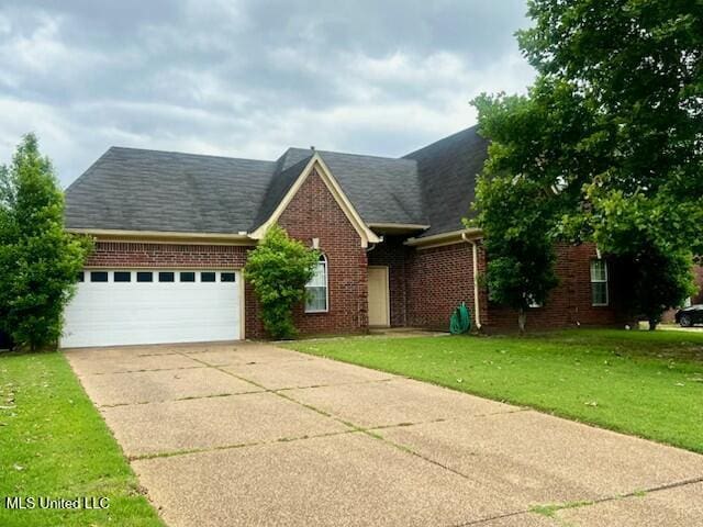 9064 Kyle Duran Ln, Olive Branch, MS 38654 - view of front of property featuring brick siding, a garage, concrete driveway, a front lawn, and a shingled roof
