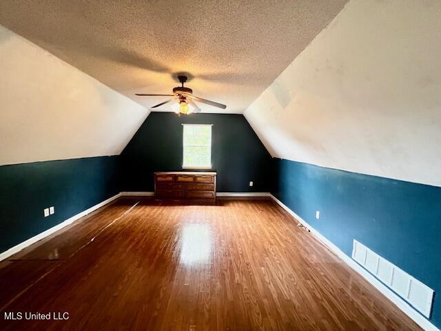9064 Kyle Duran Ln, Olive Branch, MS 38654 - additional living space with a ceiling fan, wood finished floors, lofted ceiling, and a textured ceiling