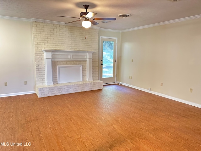 unfurnished living room featuring a fireplace, a textured ceiling, light hardwood / wood-style floors, ceiling fan, and ornamental molding