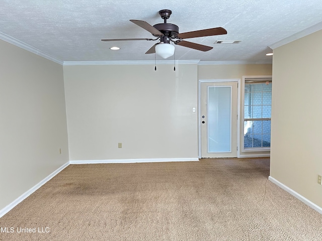 spare room with ornamental molding, carpet floors, a textured ceiling, and ceiling fan