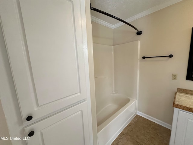 bathroom featuring shower / washtub combination, a textured ceiling, tile patterned floors, vanity, and ornamental molding