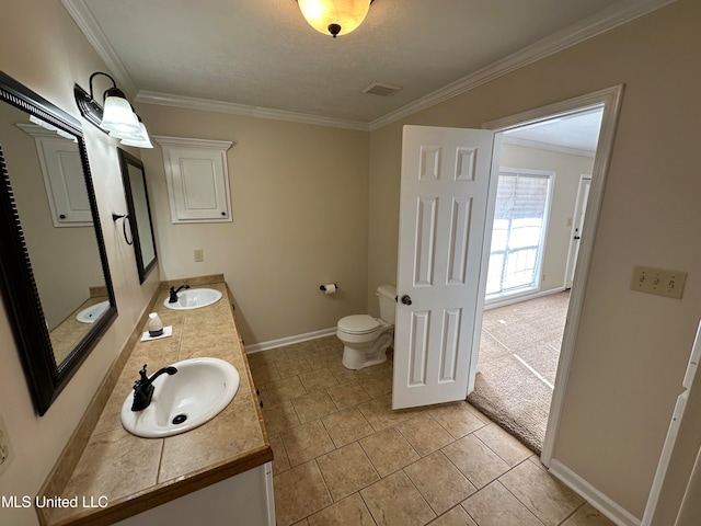 bathroom with vanity, toilet, crown molding, and tile patterned flooring