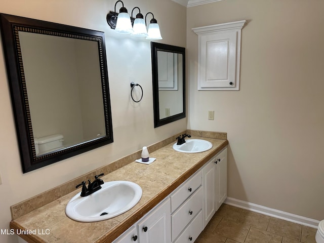 bathroom featuring vanity, toilet, ornamental molding, and tile patterned flooring