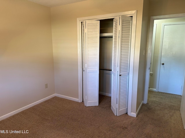 unfurnished bedroom featuring carpet floors and a closet