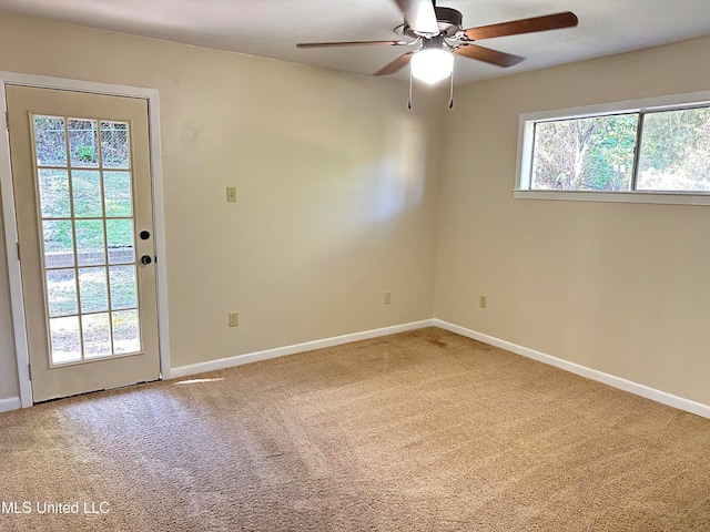 empty room featuring carpet flooring and ceiling fan