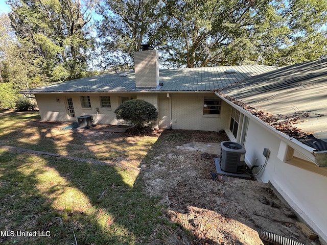 rear view of house with central AC unit