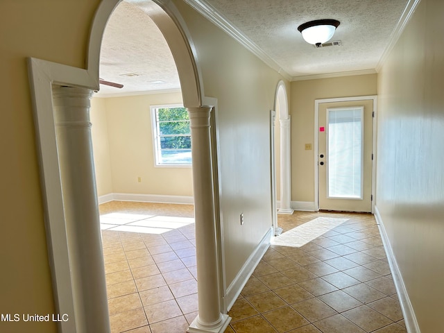 interior space with ornamental molding, a textured ceiling, and light tile patterned floors