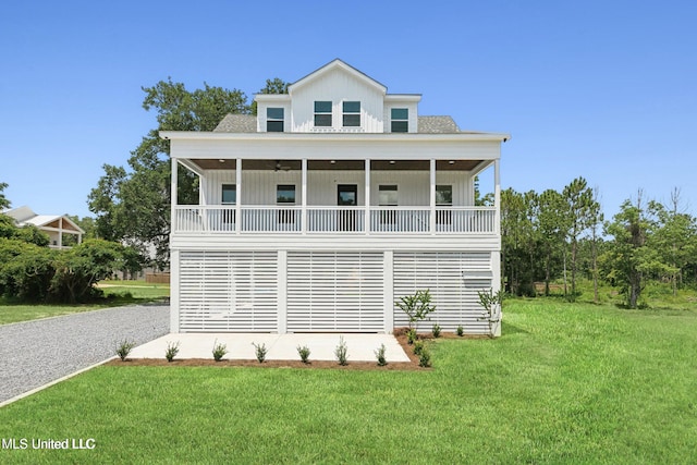 225 Magnolia Ave, Pass Christian, MS 39571 - view of front of home with board and batten siding, a front yard, and ceiling fan