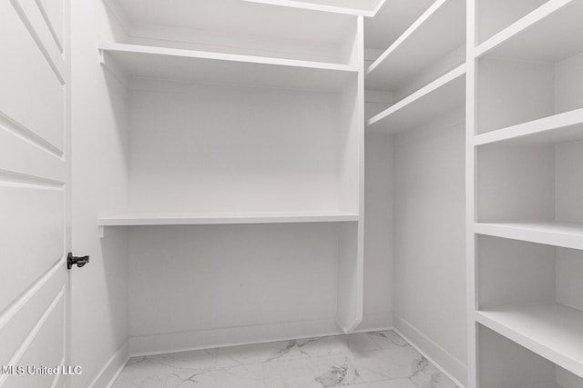 225 Magnolia Ave, Pass Christian, MS 39571 - walk in closet with marble look tile flooring