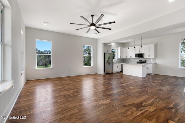 225 Magnolia Ave, Pass Christian, MS 39571 - unfurnished living room with dark wood-style floors and ceiling fan
